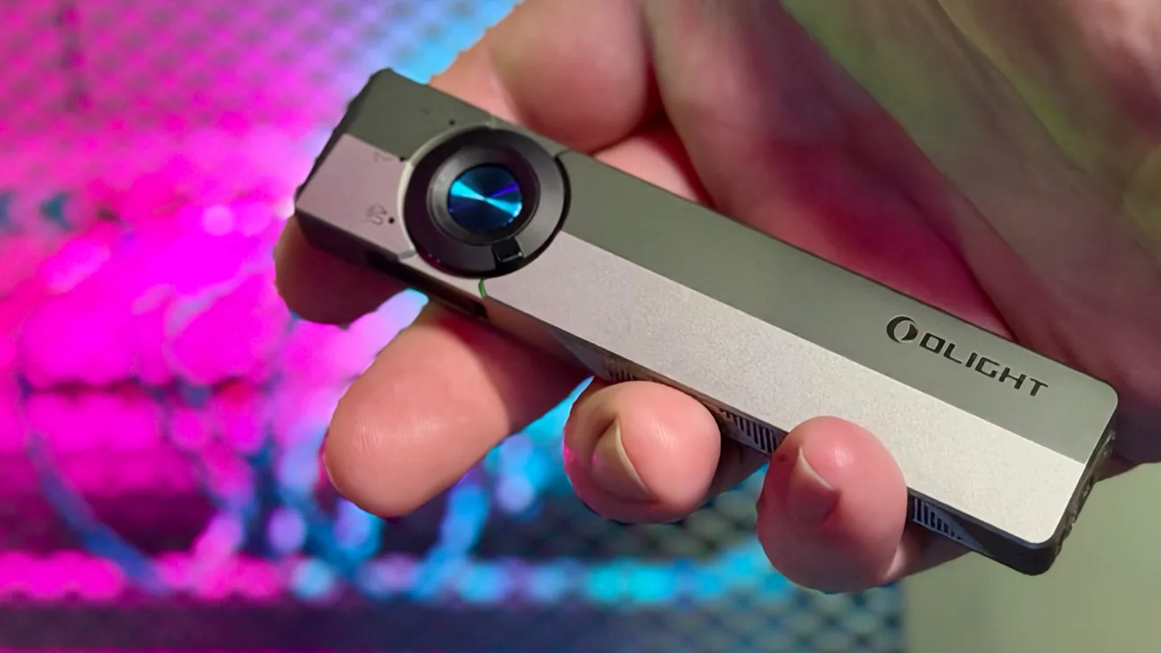 The Olight ArkPro held in hand, silver graphite unit